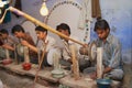 People work in a workshop creating traditional floral marble design, produced by muslim Bharai community in Agra, India.