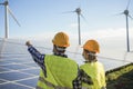 People working for alternative energy farm - Wind turbine power generators process and solar panels