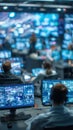 People Working In A Dark Control Room With Many Monitors Displaying Blue Data And Screens Royalty Free Stock Photo