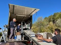 People working in mobile wine bottling truck, Le Tholonet, France, 7.04.23.