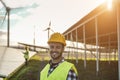 People working for solar panels and wind turbines - Renewable energy concept - Focus on man face Royalty Free Stock Photo