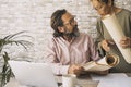 People working together at the desktop in the office with paper charts and laptop computer. Concept of man and woman working Royalty Free Stock Photo