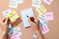 People write down an important note, using on the paper stickers Royalty Free Stock Photo