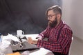 People, writer and hipster concept - young stylish writer working on typewriter Royalty Free Stock Photo