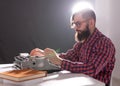 People, writer and hipster concept - young stylish writer working on typewriter Royalty Free Stock Photo