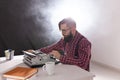 People, writer and hipster concept - young stylish writer working on typewriter Royalty Free Stock Photo