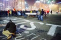People writting message on concrete at protest, Bucharest, Romania Royalty Free Stock Photo