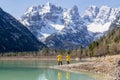 People in yellow coats photographing the mesmerizing landscape of the Crater lake