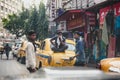 People with yellow vintage taxi on the street in Kolkata, India Royalty Free Stock Photo