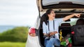 People young woman traveler and tourism holding map and pointing trips travel on hatchback car to destination leisure travel Royalty Free Stock Photo