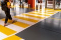 People at the zebra crossing underground Parking. Parking garage underground interior, pedestrian crossing, neon lights