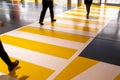 People at the zebra crossing underground Parking. Parking garage underground interior, pedestrian crossing, neon lights