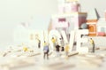 Peopleminiature preparing Valentine`s day with `LOVE` text ,soft and selective focus as pastel toned.