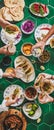 Peoples hands with drinks over mexican taco party table