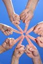 Peoples hands pointing at one spot