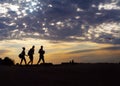 Peoples in silhouette walking on the background of sunset and cl Royalty Free Stock Photo