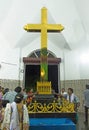 Peoples touching and praying in front of Golden Cross in St.Thomas Syro-Malabar church Malayattoor Royalty Free Stock Photo