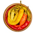 Peperoni pickles, pickled whole chili peppers in wooden bowl Royalty Free Stock Photo