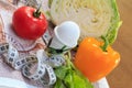 Pepper, egg, cabbage, tomato, salad and ruler on the table Royalty Free Stock Photo