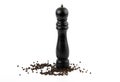 Pepper mill with black peppercorns on white background. Royalty Free Stock Photo