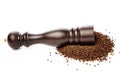 Pepper mill on peppercorns heap on white