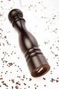 Pepper mill and peppercorns on white Royalty Free Stock Photo