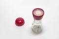 Empty glass pepper mill with two degrees of grind, with the red