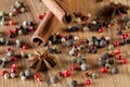 Pepper mix, cinnamon, truestar on wooden background Royalty Free Stock Photo