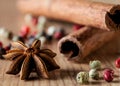 Pepper mix, cinnamon, truestar on wooden background Royalty Free Stock Photo