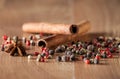 Pepper mix, cinnamon, truestar on wooden background Royalty Free Stock Photo