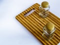 Pepper pot and salt shaker stand empty on a cutting board on a white background