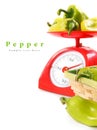 Pepper on scales and in a basket. Royalty Free Stock Photo