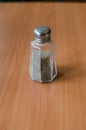 Pepper shaker on wooden table Royalty Free Stock Photo