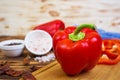 Pepper, tomato, salt, different spice on wooden background Royalty Free Stock Photo