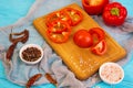 Pepper, tomato, salt, different spice on wooden background Royalty Free Stock Photo