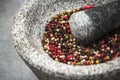 Peppercorn seed in granite mortar or pestle