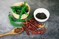 Peppercorns on basket and dried chilli on dark background - fresh green peppercorn and black pepper seed on white cup for Royalty Free Stock Photo