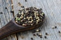 Peppercorns on rustic wooden table