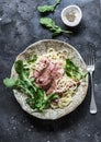 Peppered steak pasta. Spaghetti pasta with sliced beef steak and rocket salad on a dark background, top view Royalty Free Stock Photo