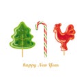 Peppermint candy canes. Christmas tree and rooster on stick Royalty Free Stock Photo