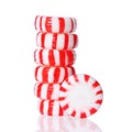 Peppermint candy tower on white. Red striped peppermint Christmas candy