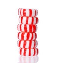 Peppermint candy tower on white. Red striped peppermint Christmas candy