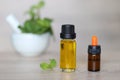 Peppermint essential oil in glass bottles on wooder background Royalty Free Stock Photo