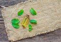 Peppermint essential oil in bottle and fresh twig on wooden background Royalty Free Stock Photo