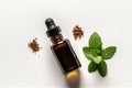 Peppermint Essential Oil In Small Brown Bottle Next To Peppermint On White Background, Top View. Generative AI