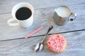 Peppermint stick dough nut next to coffee and a jug of milk Royalty Free Stock Photo