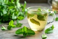 peppermint tea in a mug with fresh peppermint leaves on table Royalty Free Stock Photo