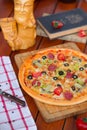 Pepperoni pizza with bell pepper, tomato slices, mushroom and olives.