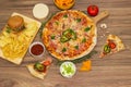 Pepperoni pizza and pizza Capricciosa with mozzarella cheese, ham, tomato sauce, salami, mushroom, pepper, spices and fresh basil. Royalty Free Stock Photo