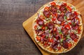 Pepperoni Pizza with Mozzarella cheese, salami, Tomato sauce, pepper, onion, Spices. Italian pizza on wooden table Royalty Free Stock Photo